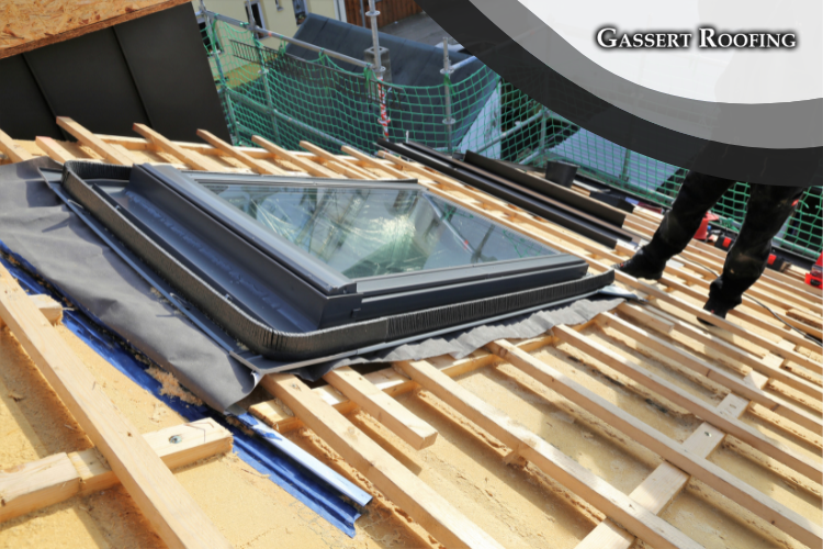 Gassert Roofing team members expertly installing a skylight on a Palmyra roof, ensuring a seamless and weather-resistant fit.
