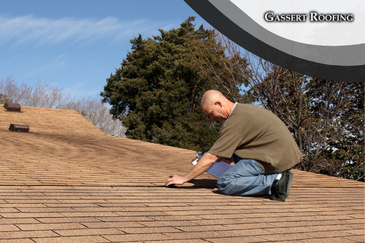 Homeowner in Manheim examining roof shingles that need repair.