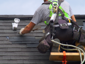 Campbelltown roofing services by Gassert Roofing, showing a roofer applying protective measures.